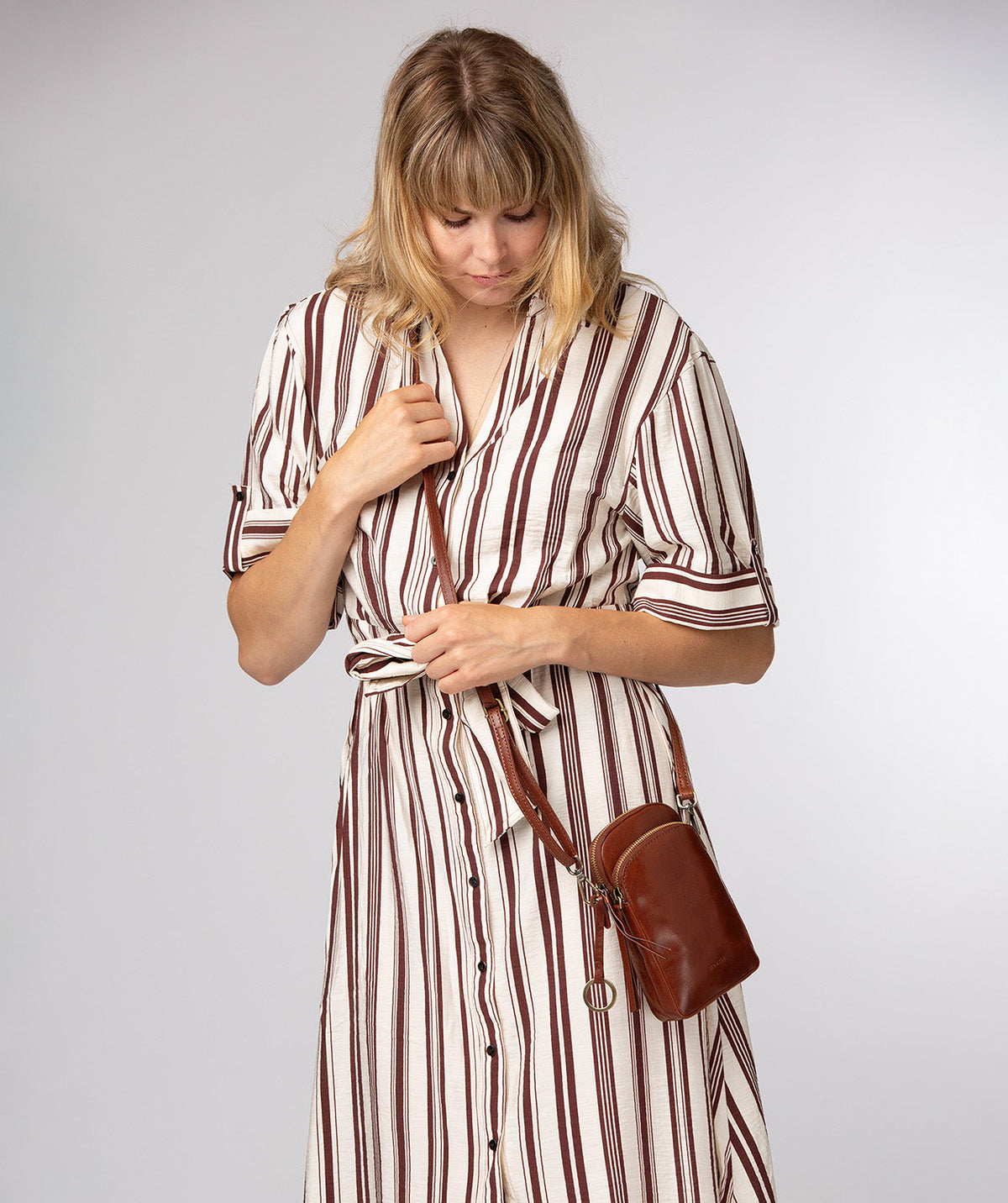 Raven crossbody bag side profile with brass hardware