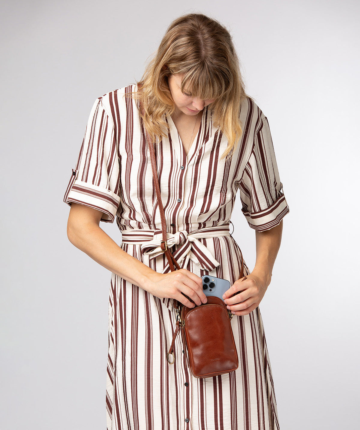 Raven crossbody bag flat lay showing depth and texture