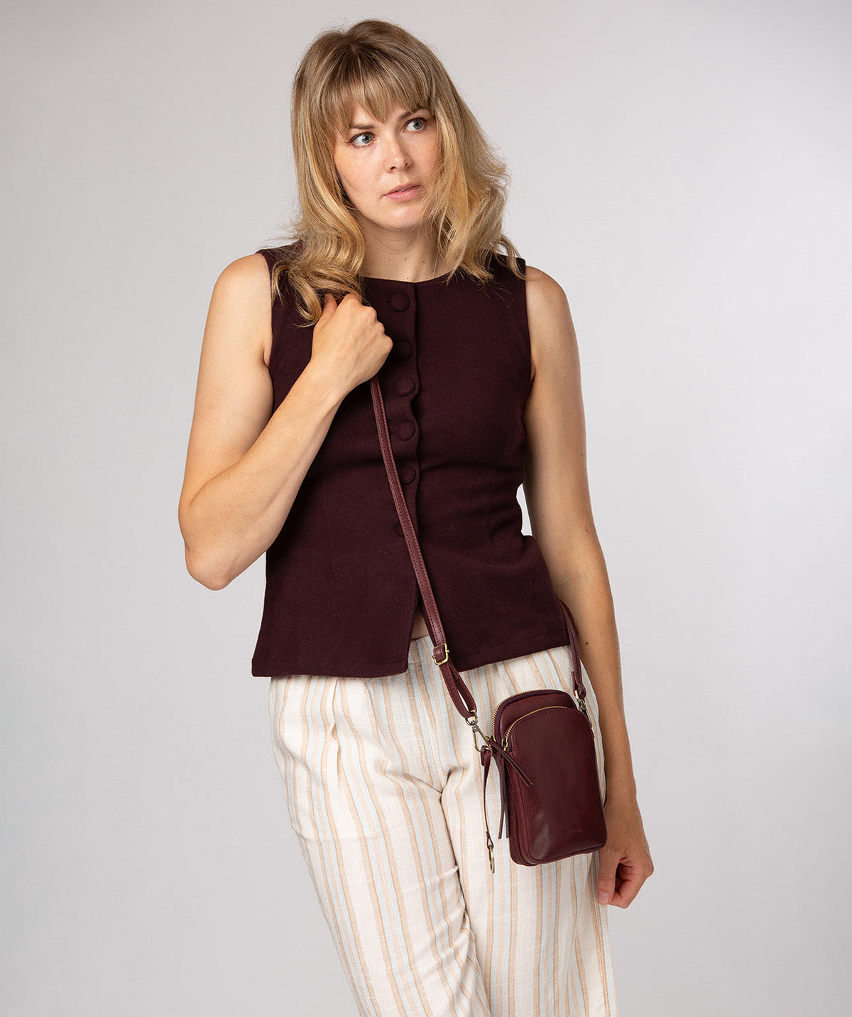 Conkca London Raven plum leather crossbody phone bag front view