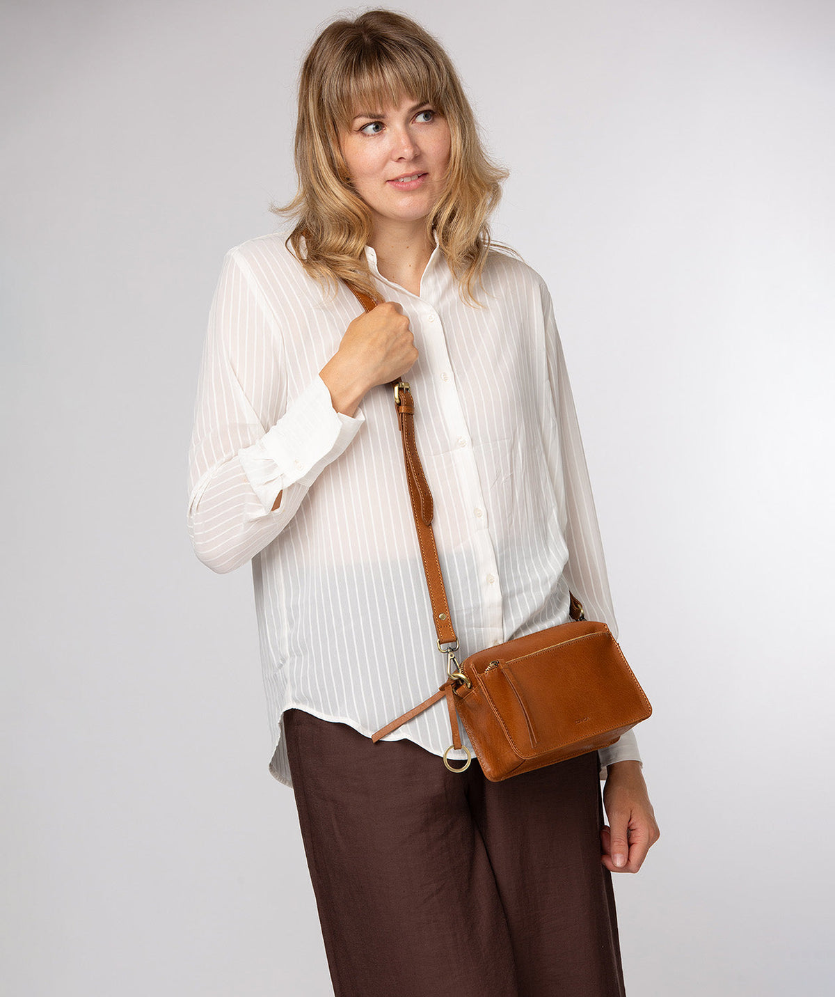 Conkca London Azalea dark tan leather crossbody bag front view