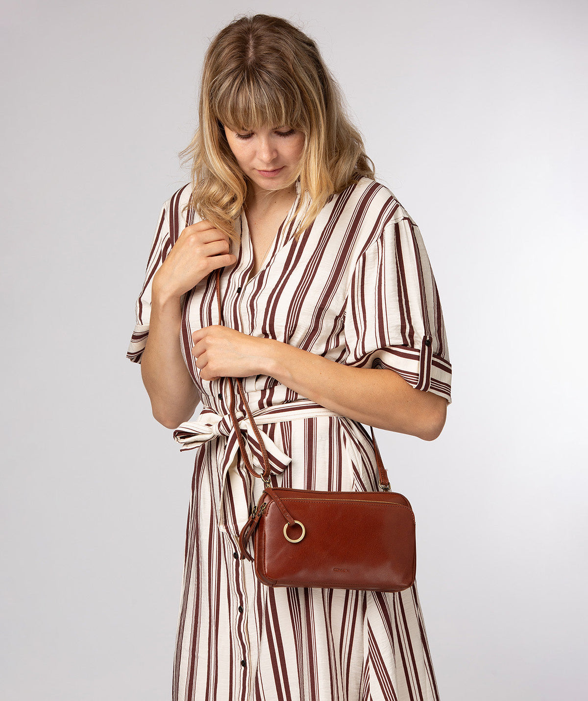 Birdy crossbody bag side profile showing adjustable leather strap
