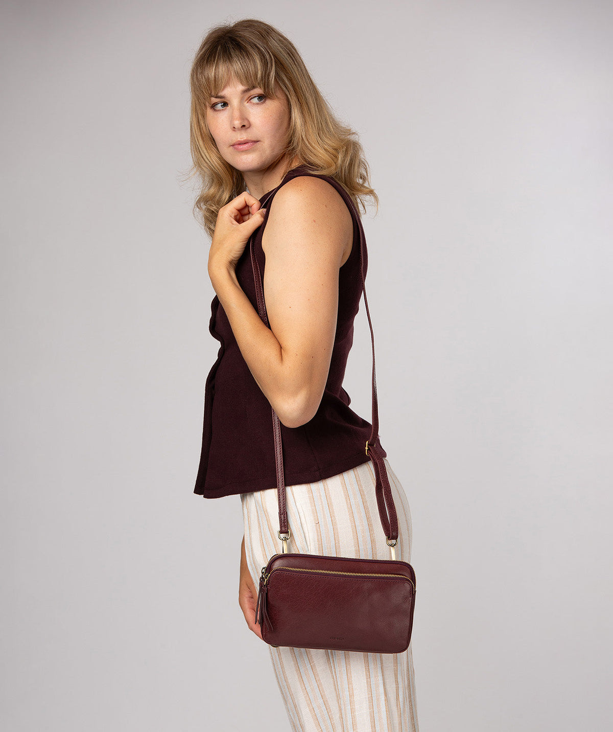 Conkca London Birdy plum leather crossbody bag front view