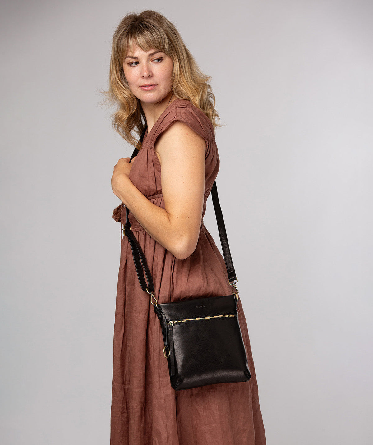 Black leather crossbody bag angled side profile
