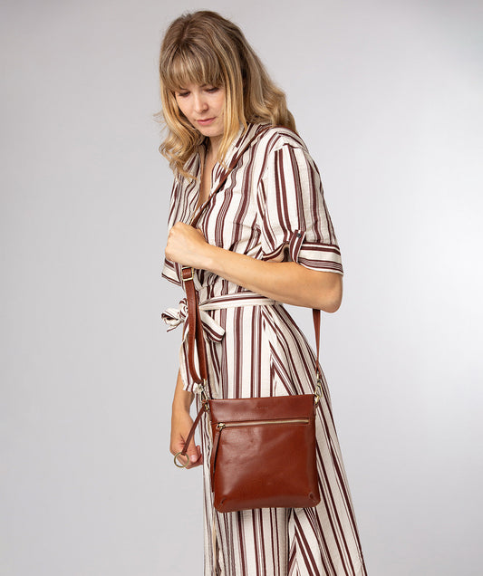 Conkca London Dove conker brown leather crossbody bag front view
