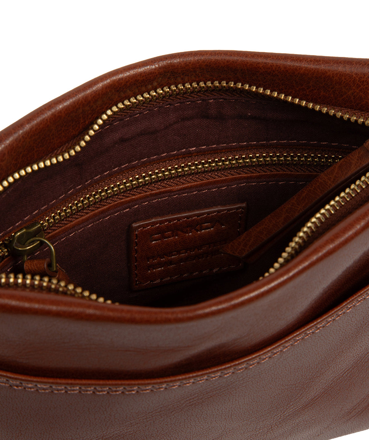 Concealed zip-over top and brass hardware detail