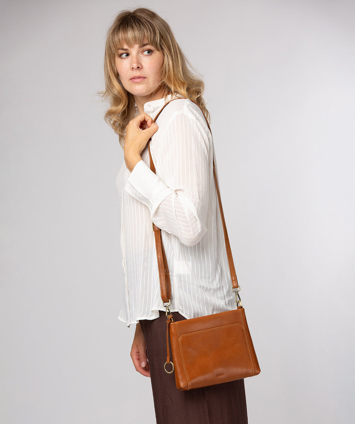 Conkca London Yew dark tan leather crossbody bag front view