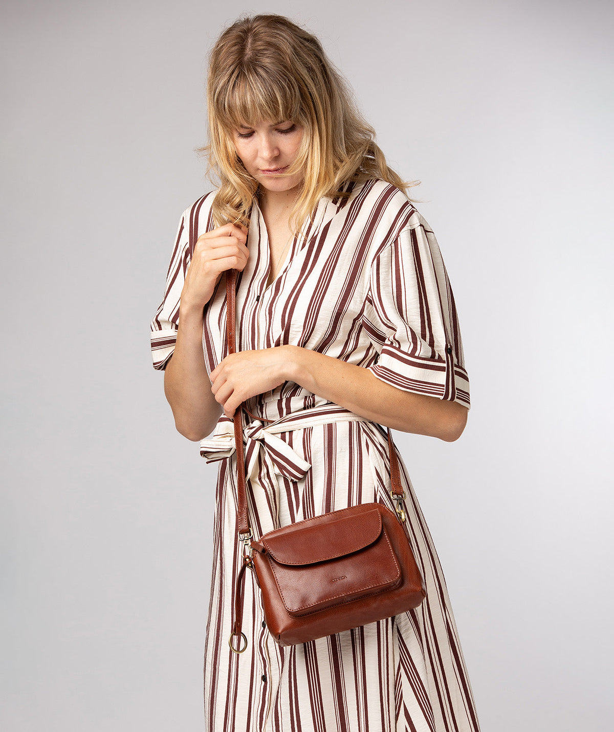 Conker Brown leather crossbody bag side profile showing strap