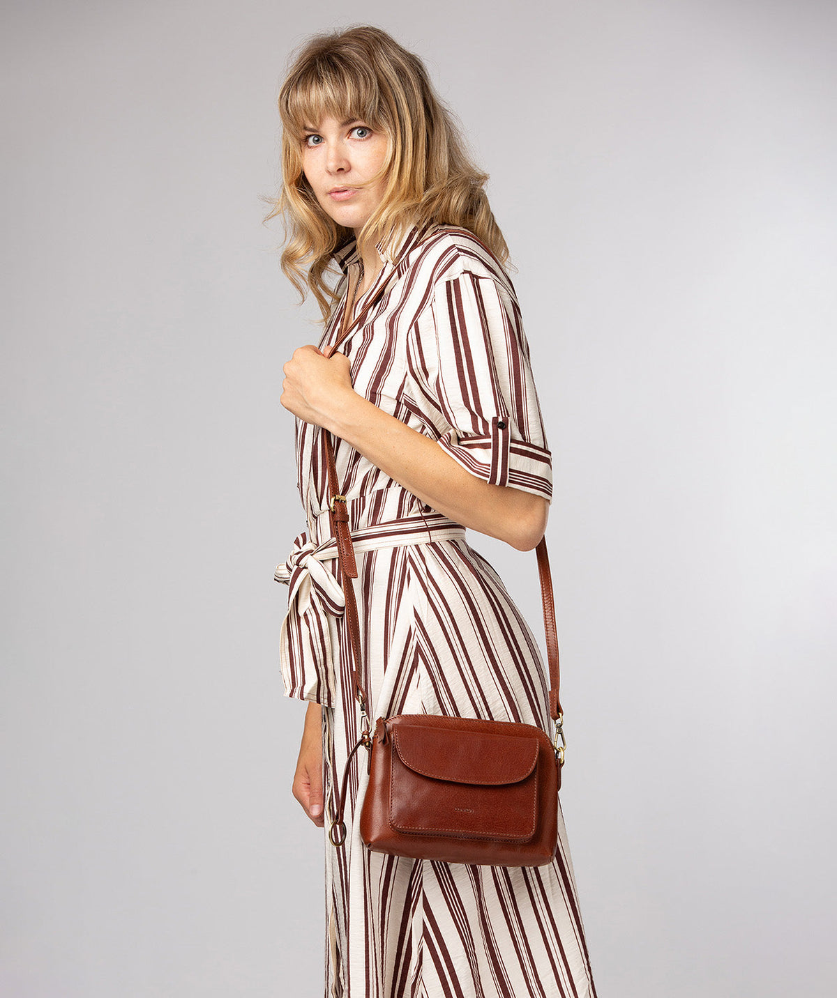 Embossed Conkca logo and charm on crossbody bag