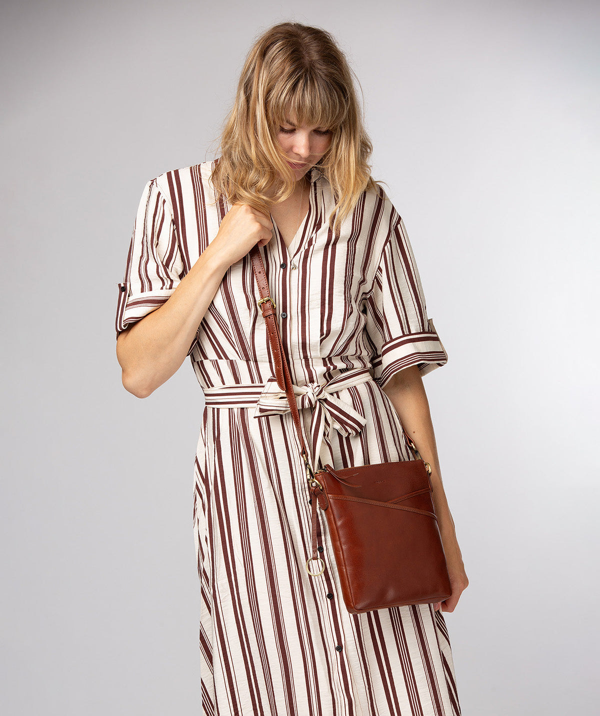 Conkca London Holly conker brown leather crossbody bag front view