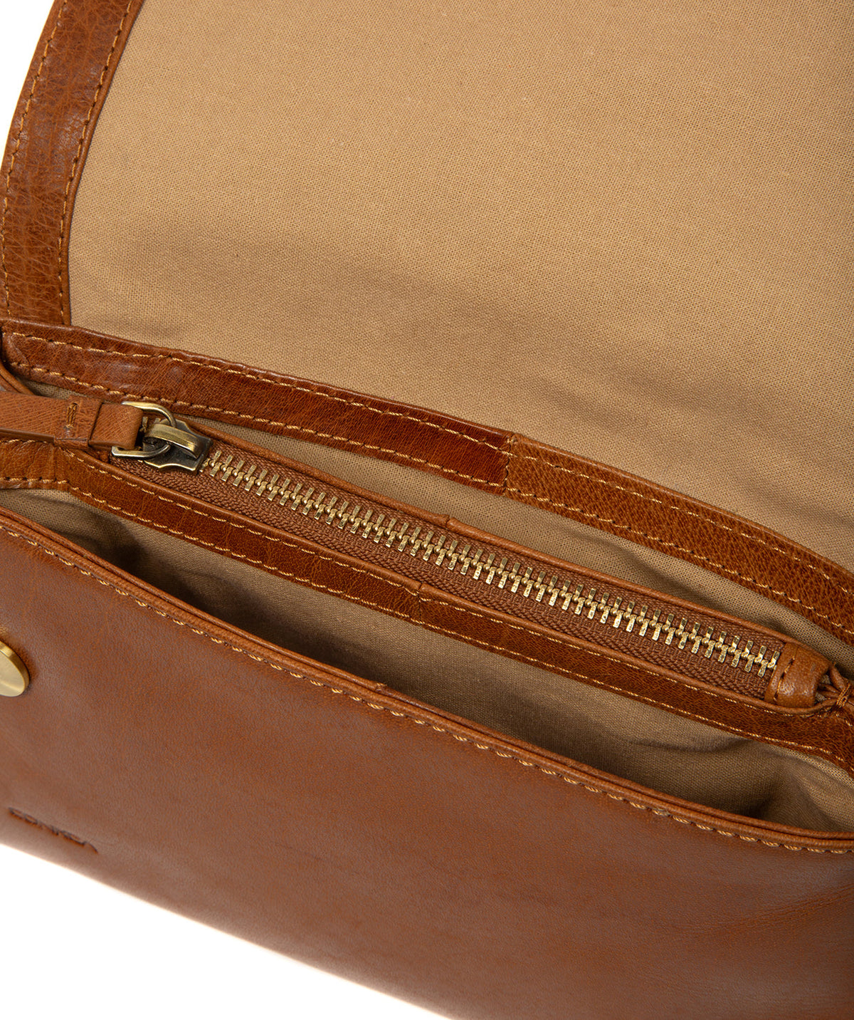 Side profile showing brass hardware and leather strap